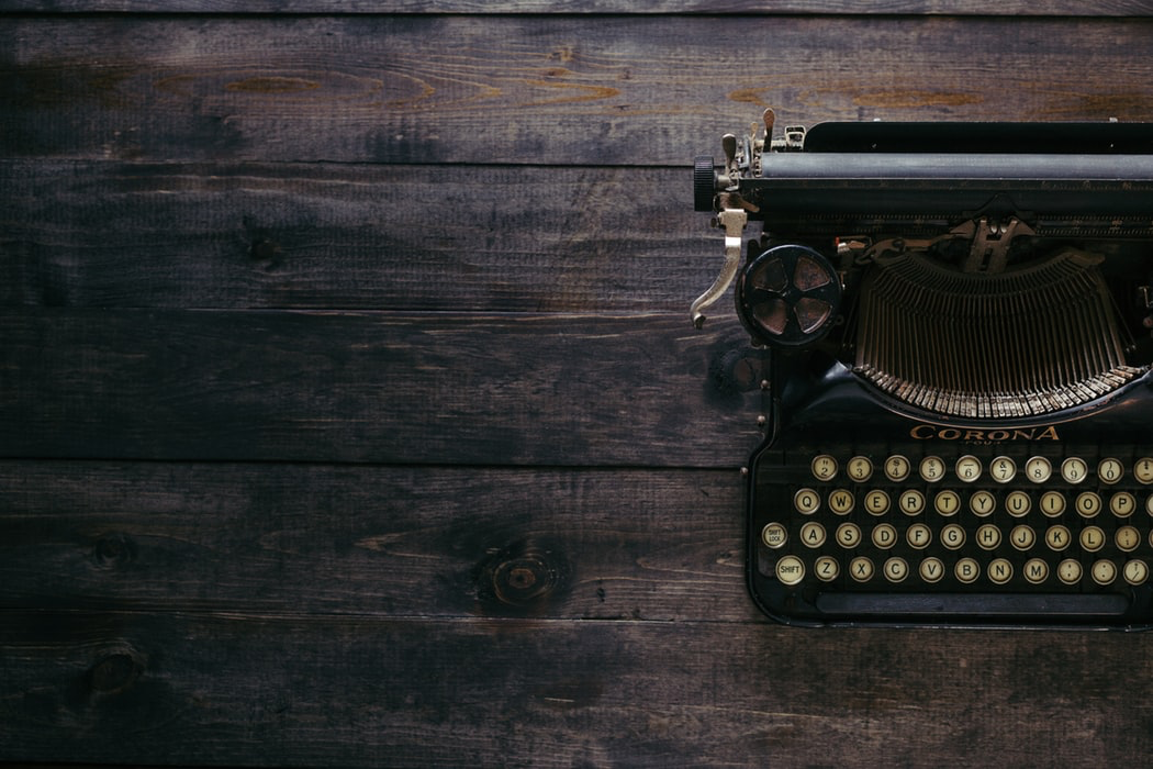 Vintage typewriter on a wooden table.